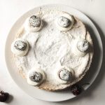 Powdered Sugar - white and black round cake with black berries on white ceramic plate