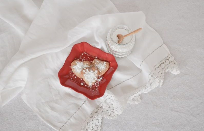 Turbinado Sugar - flat lay photography of heart-shaped cookies on red plate