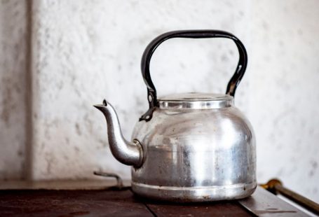 Tea Pot - stainless steel kettle on brown wooden table