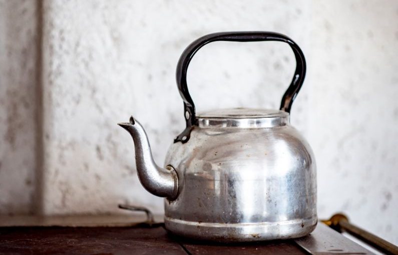 Tea Pot - stainless steel kettle on brown wooden table