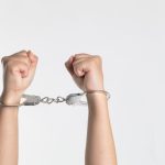 Shackles - person showing handcuff