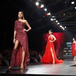 Fashion Runway - woman wearing maroon one-shoulder slit-side dress