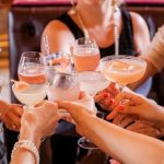 Cocktail Party - woman in black tank top holding clear wine glass