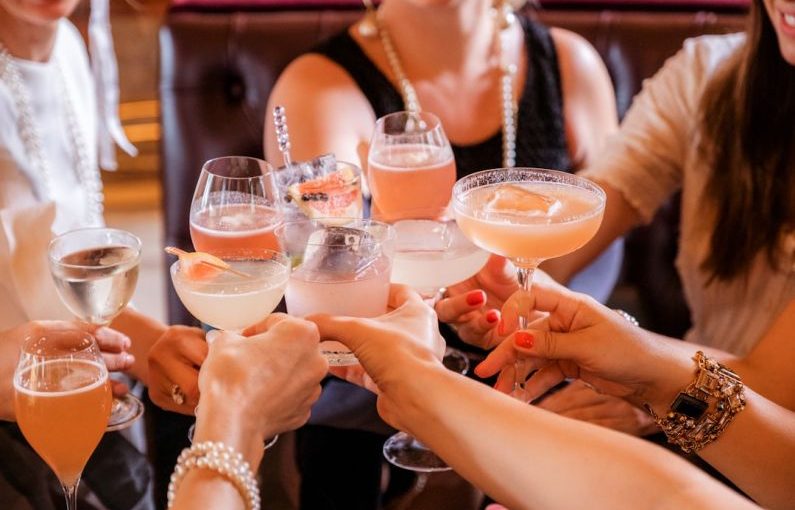 Cocktail Party - woman in black tank top holding clear wine glass