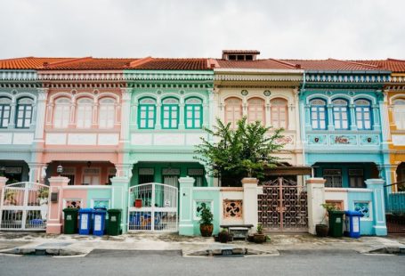 Colonial Map - a row of multicolored buildings with a tree in front of them