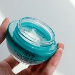 Skincare Jar - a hand holding a clear container