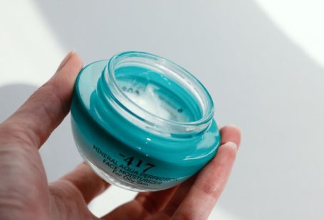 Skincare Jar - a hand holding a clear container