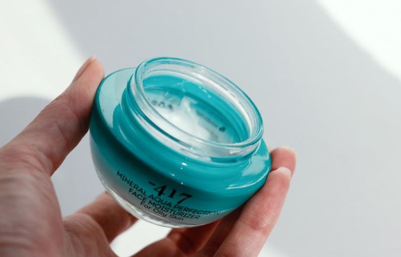 Skincare Jar - a hand holding a clear container