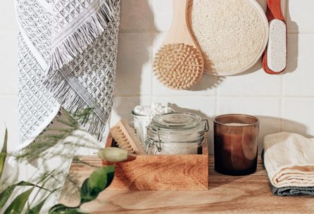 Sustainable Home - brown wooden chopping board beside clear glass jar